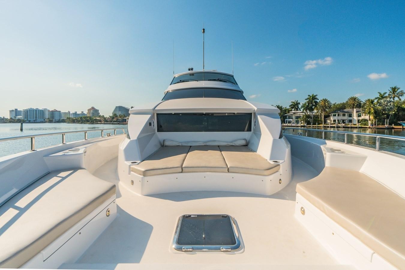 a white boat on a dock aboard 2017 HATTERAS M75 K SEA Yacht for Sale