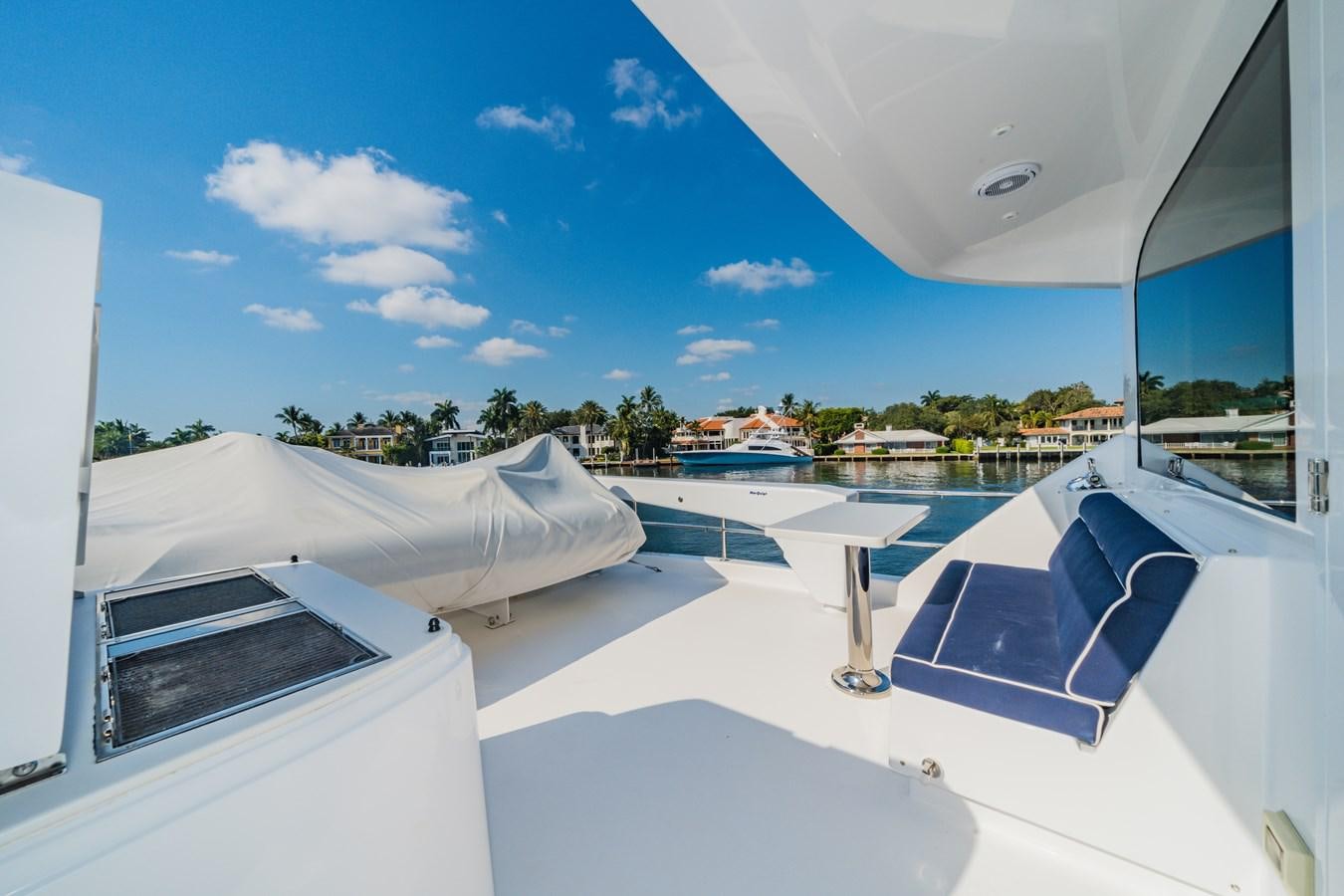 a room with a large window and a view of the beach aboard 2017 HATTERAS M75 K SEA Yacht for Sale