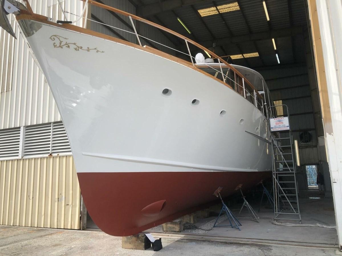 a large white ship in a warehouse aboard DOVETAIL Yacht for Sale
