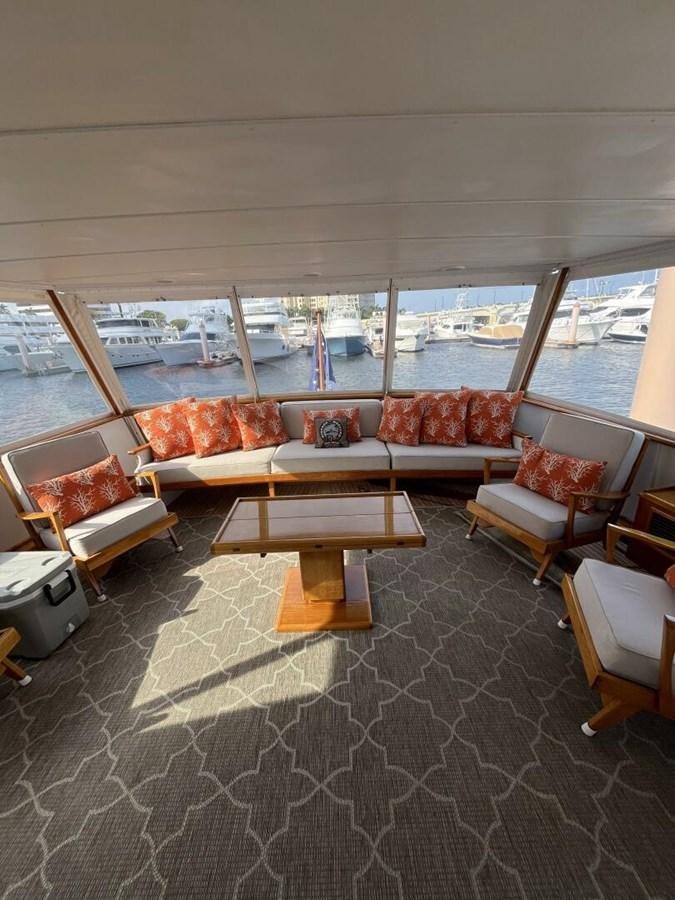 a room with a view of the water and a large boat aboard DOVETAIL Yacht for Sale