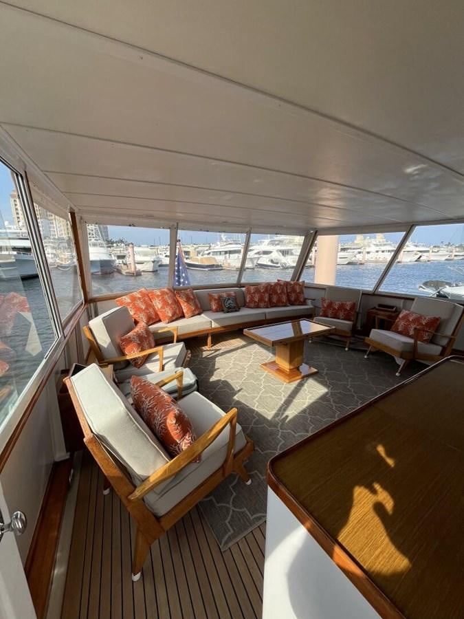 a living room with a large window aboard DOVETAIL Yacht for Sale
