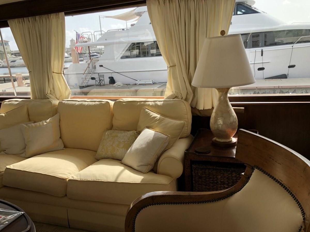 a living room with a large window aboard DOVETAIL Yacht for Sale