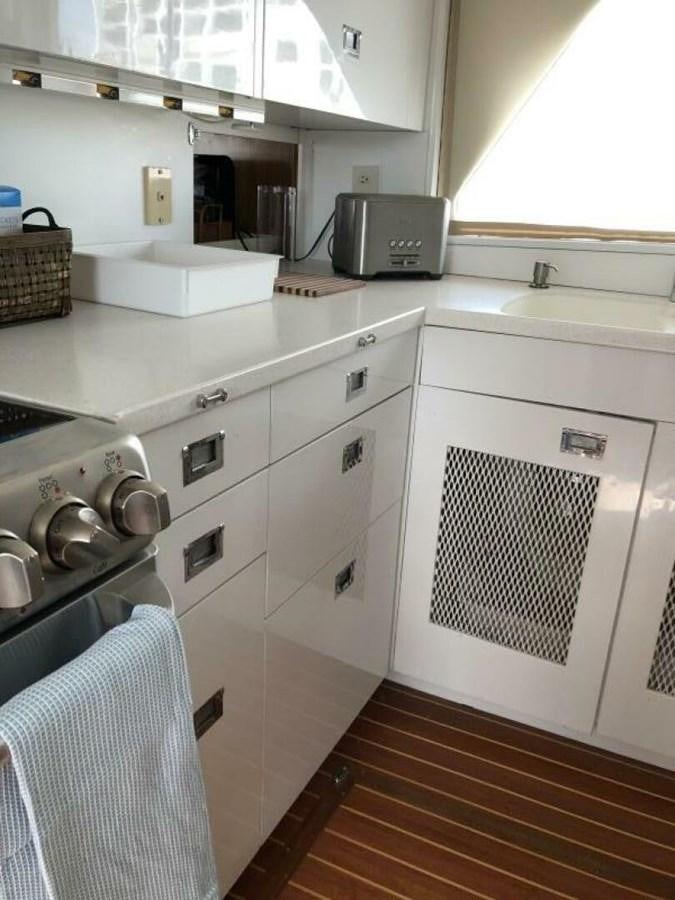 a kitchen with white cabinets aboard DOVETAIL Yacht for Sale