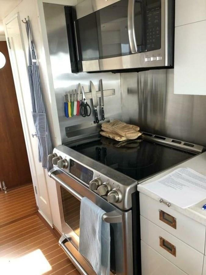 a kitchen with a stove and oven aboard DOVETAIL Yacht for Sale