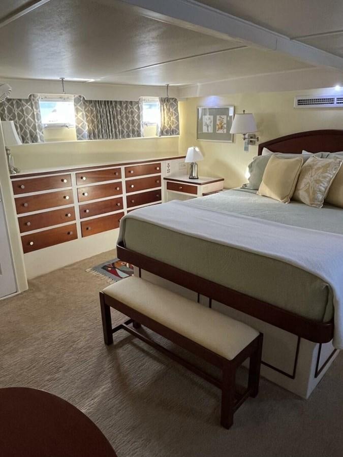 a room with a bed and a desk aboard DOVETAIL Yacht for Sale