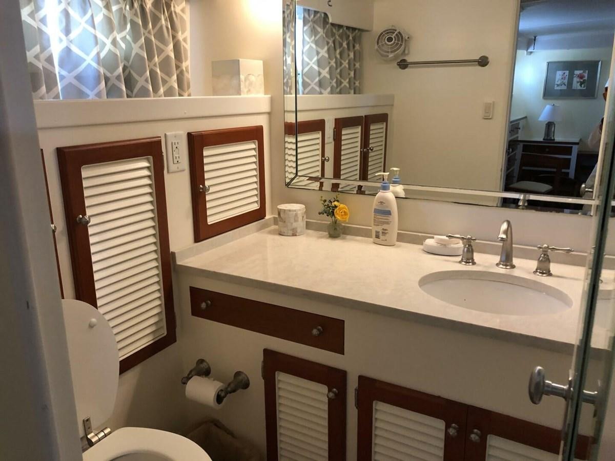 a bathroom with a sink and a toilet aboard DOVETAIL Yacht for Sale