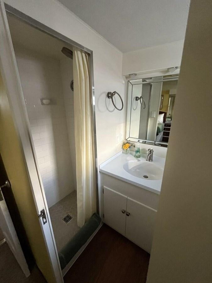 a bathroom with a sink and a mirror aboard DOVETAIL Yacht for Sale