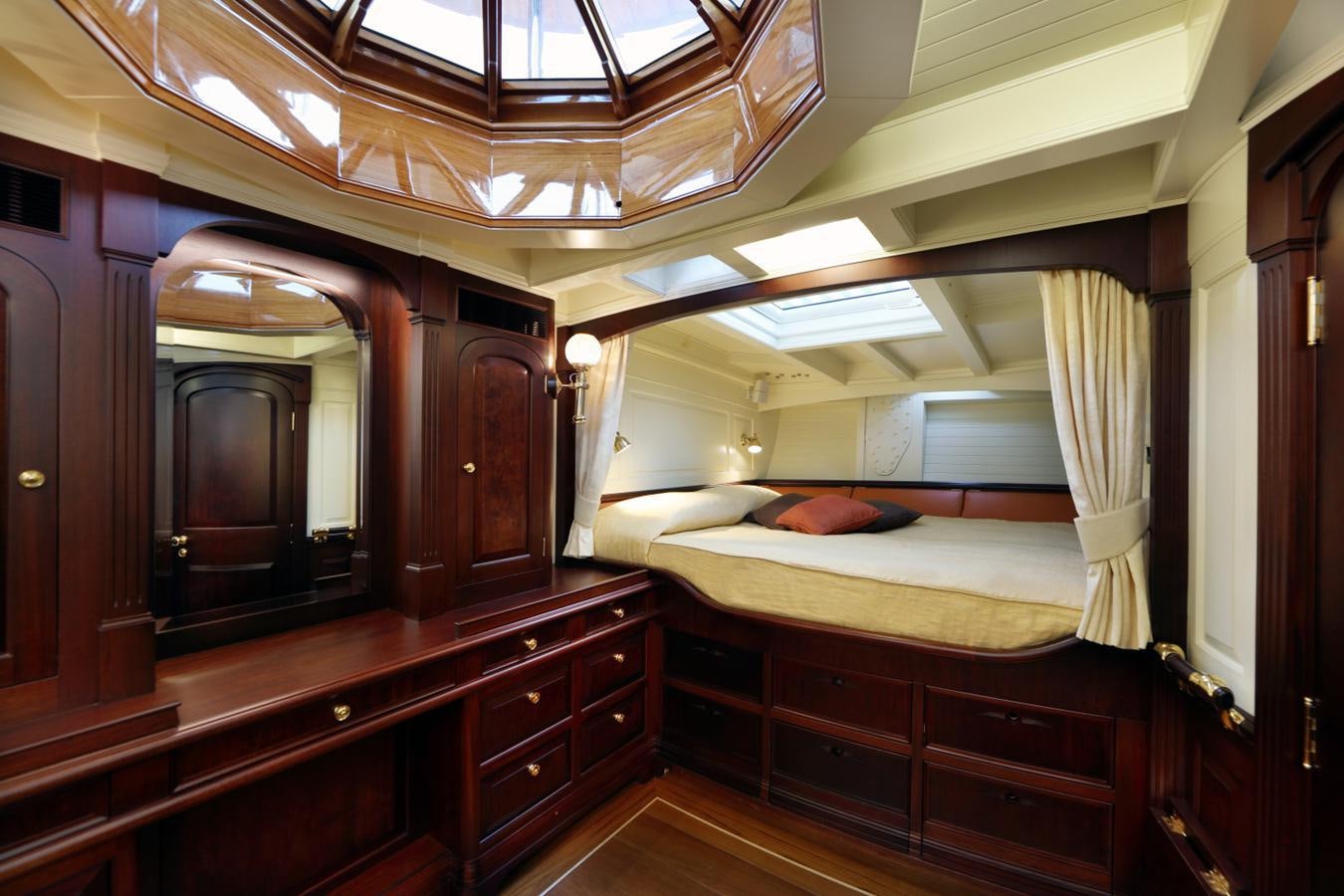 a room with a bed and a mirror aboard ASGARD Yacht for Sale