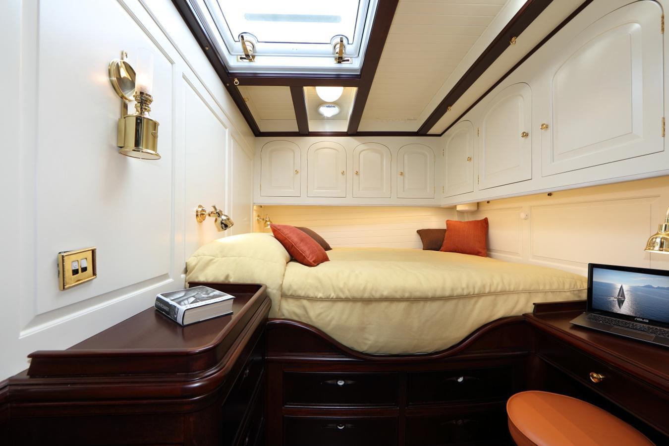 a bedroom with a bed and desk aboard ASGARD Yacht for Sale