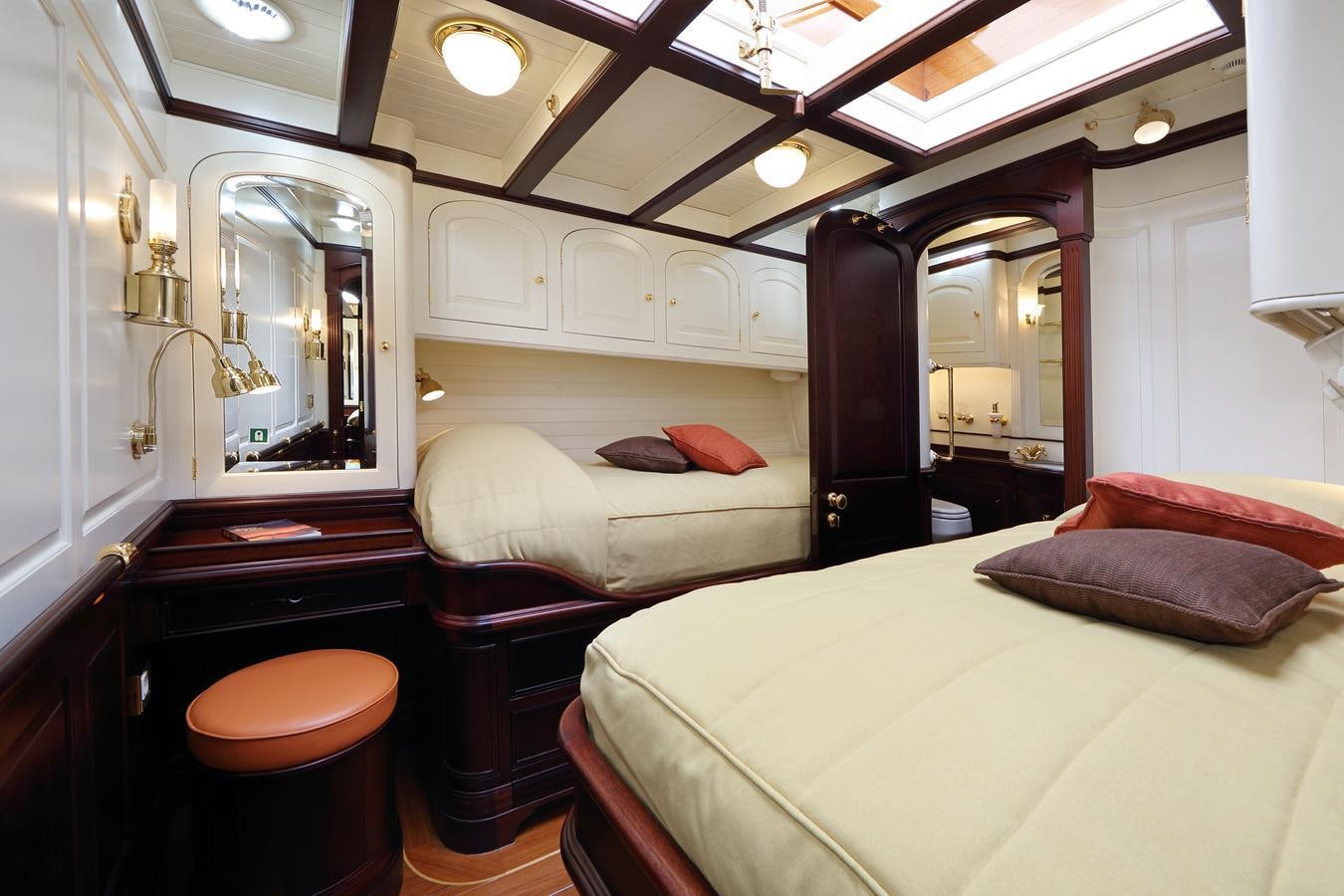 a room with a bed and a mirror aboard ASGARD Yacht for Sale