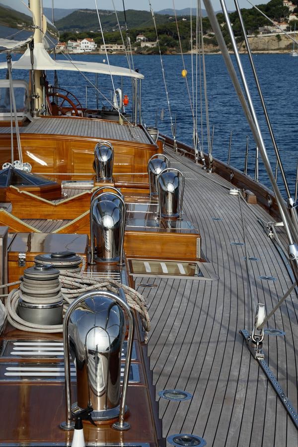 a boat with a large ship in the background aboard ASGARD Yacht for Sale