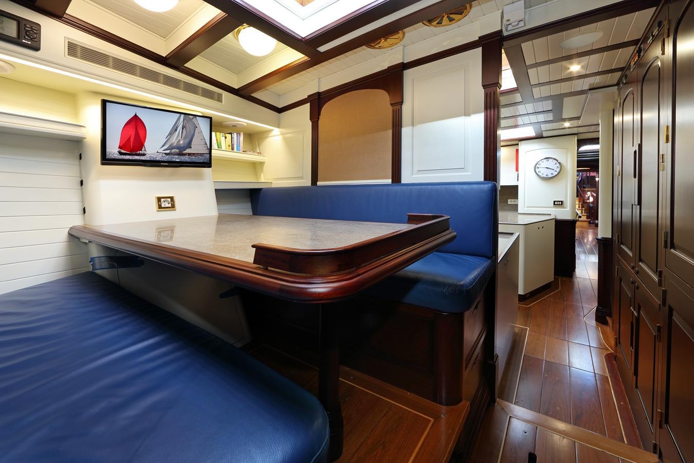 a room with a table and a tv aboard ASGARD Yacht for Sale