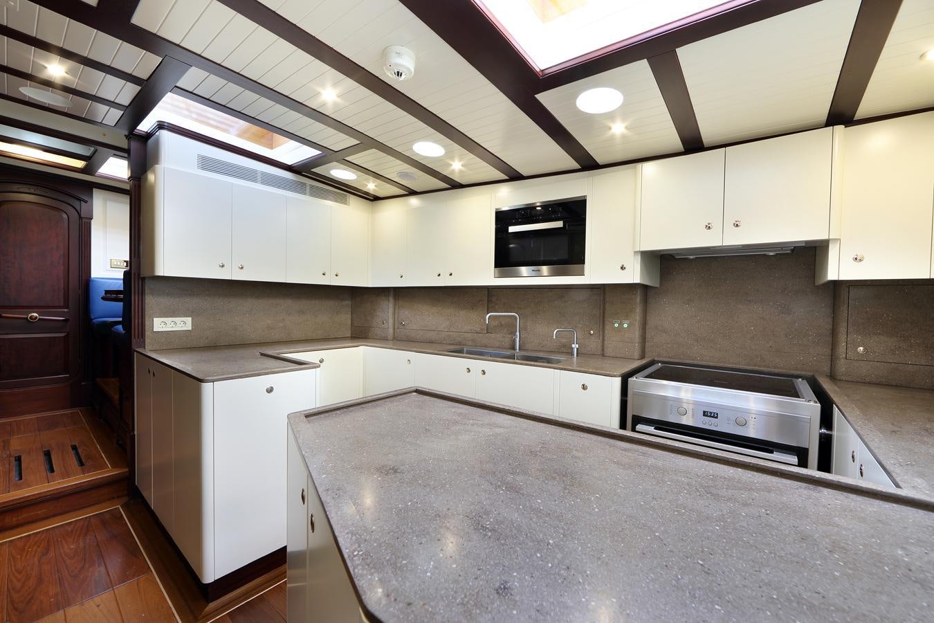 a kitchen with a large island aboard ASGARD Yacht for Sale