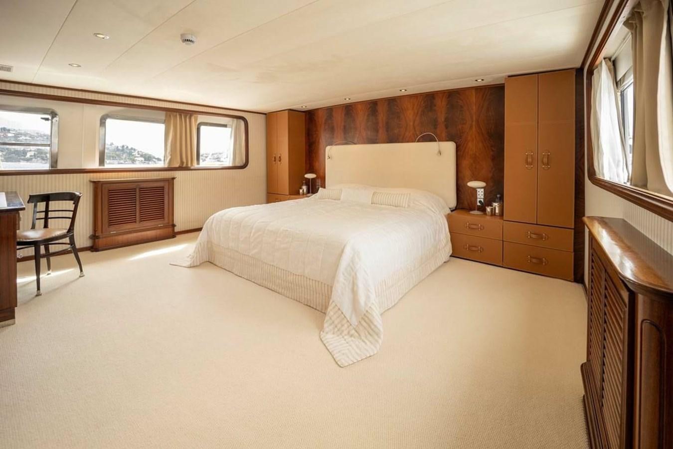 a room with a bed and a chair aboard CLASSIC 40M BENETTI Yacht for Sale
