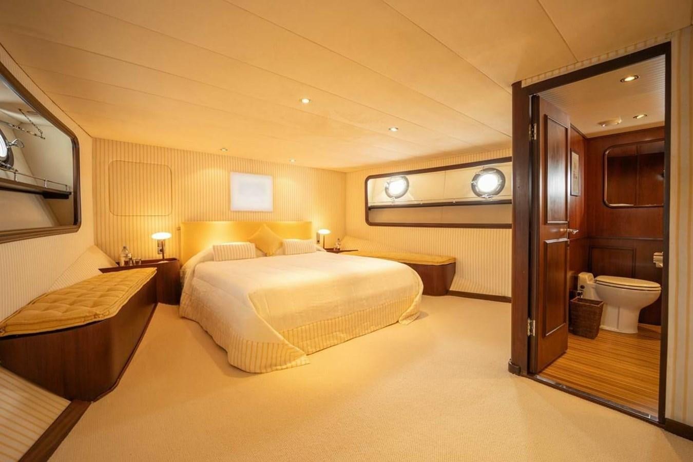 a hotel room with a bed and a mirror aboard CLASSIC 40M BENETTI Yacht for Sale