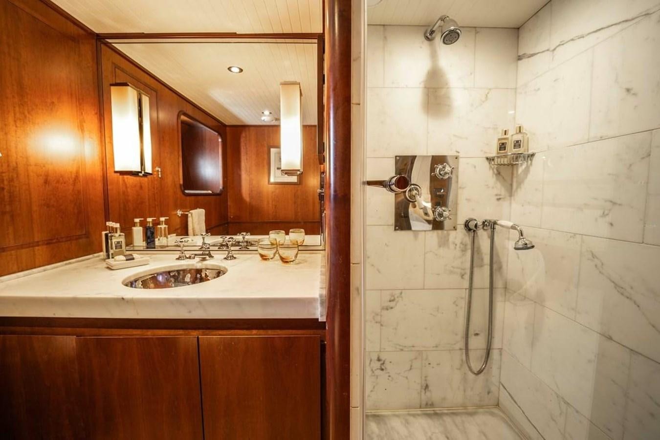 a bathroom with a sink and a mirror aboard CLASSIC 40M BENETTI Yacht for Sale