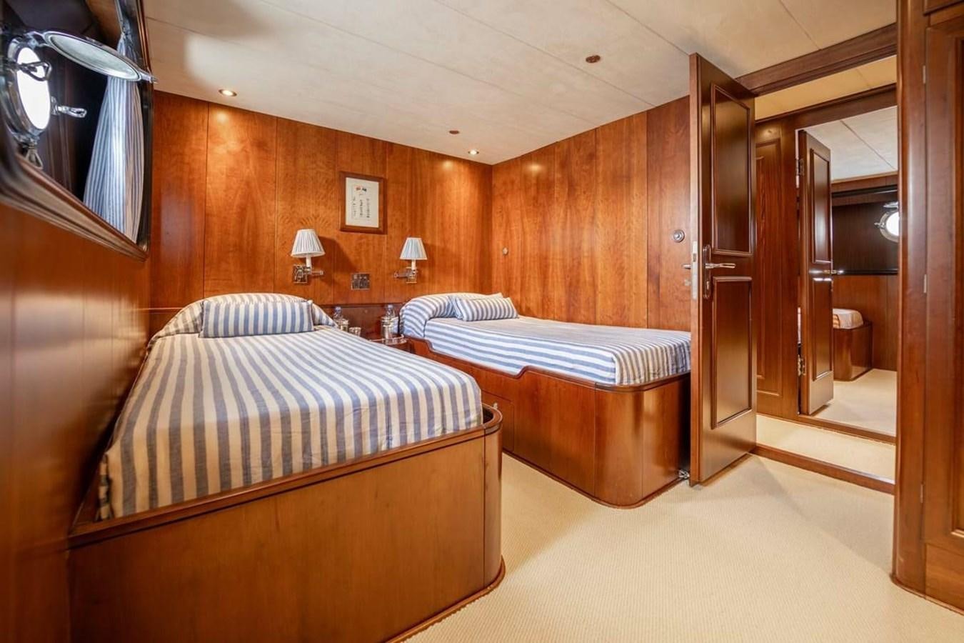 a bedroom with a bed and a television aboard CLASSIC 40M BENETTI Yacht for Sale