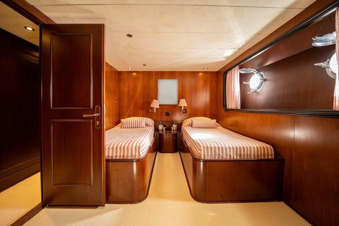 a room with a bed and a table aboard CLASSIC 40M BENETTI Yacht for Sale
