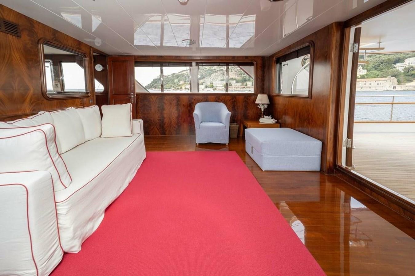 a room with a bed and a chair aboard CLASSIC 40M BENETTI Yacht for Sale