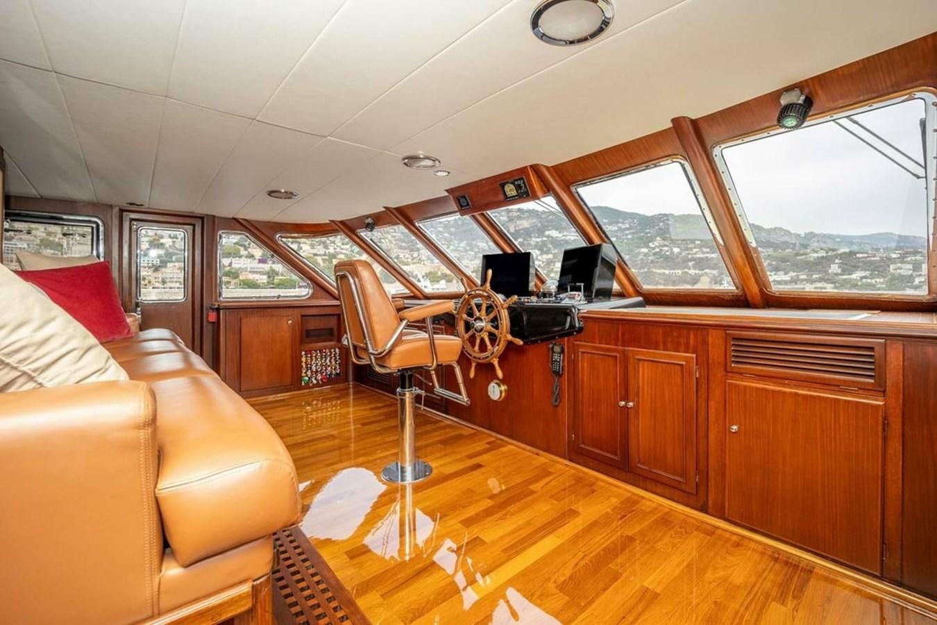 a living room with a large window aboard CLASSIC 40M BENETTI Yacht for Sale