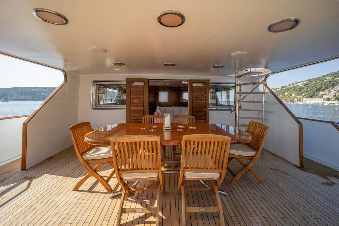 a dining table on a deck aboard CLASSIC 40M BENETTI Yacht for Sale