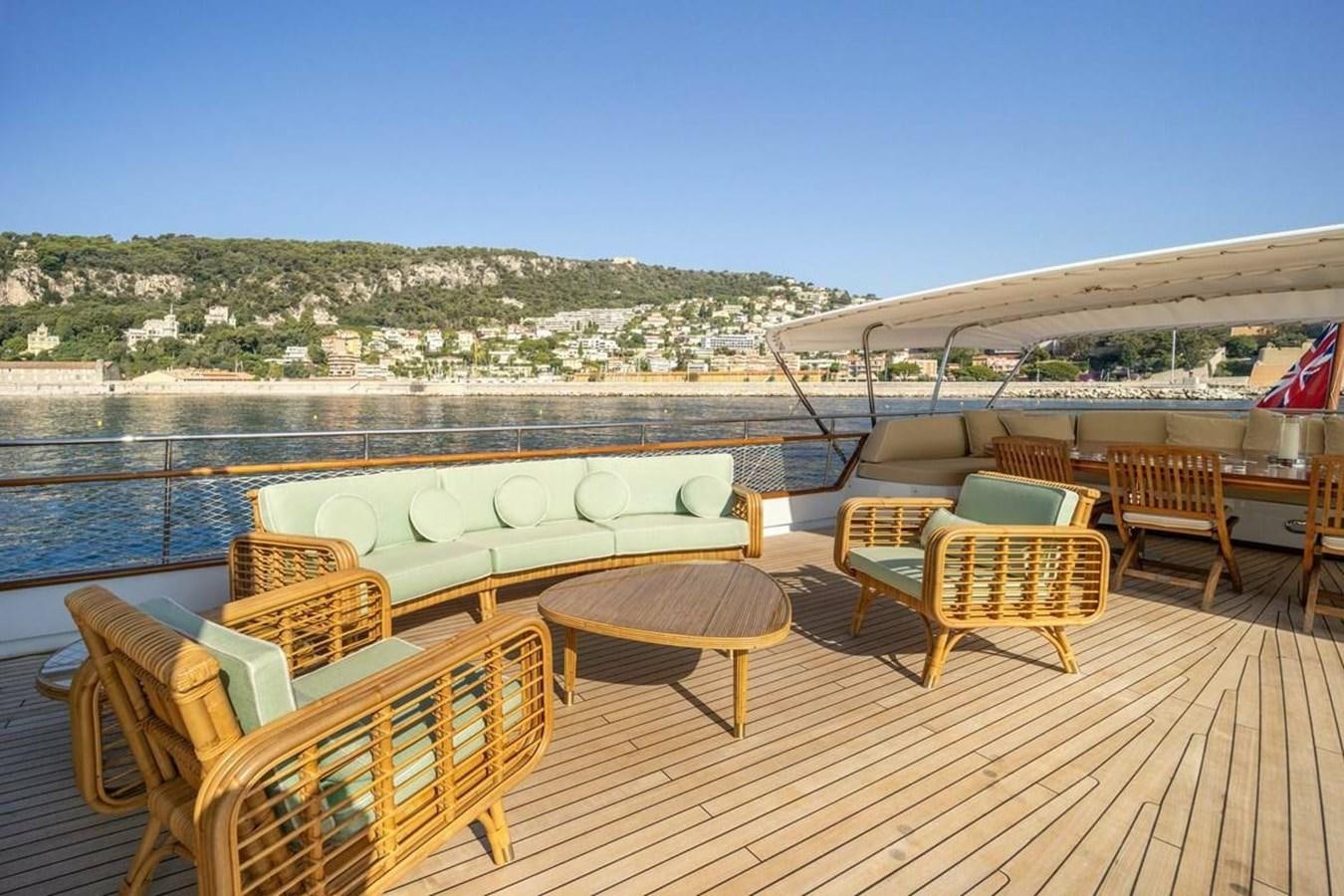 a deck with chairs and tables on it aboard CLASSIC 40M BENETTI Yacht for Sale