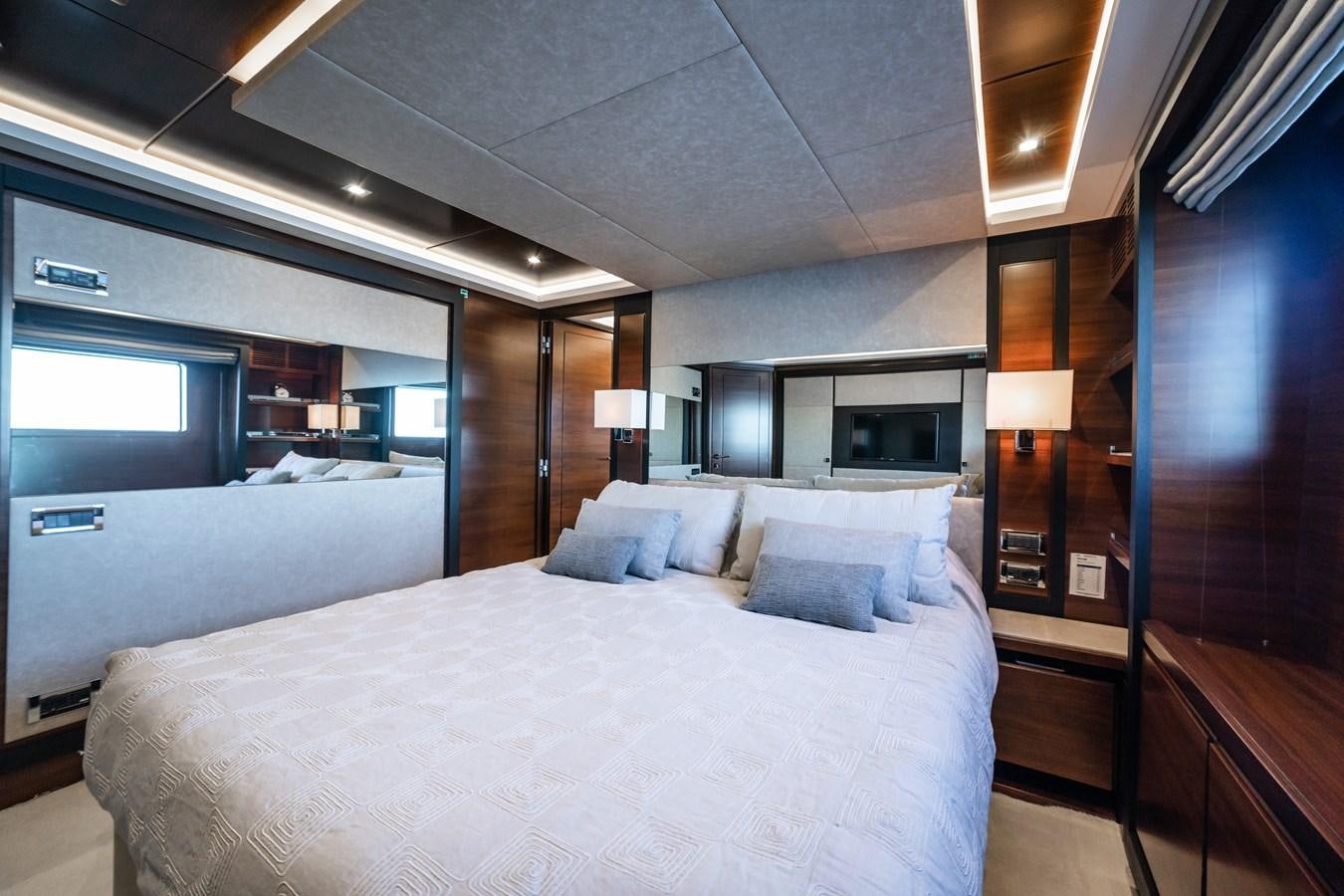 a room with a bed and a mirror aboard ADEL Yacht for Sale