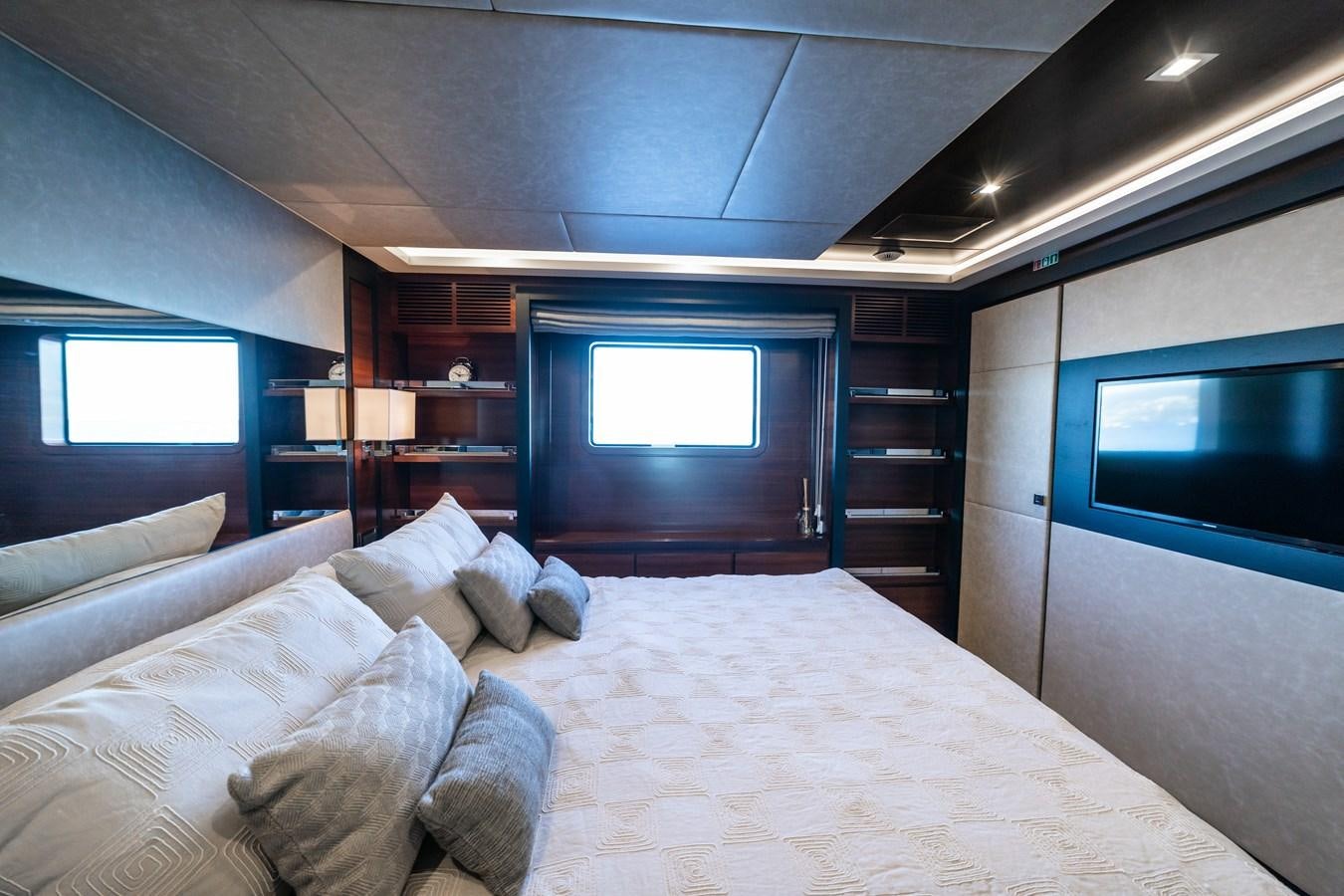 a bedroom with a bed and a tv aboard ADEL Yacht for Sale
