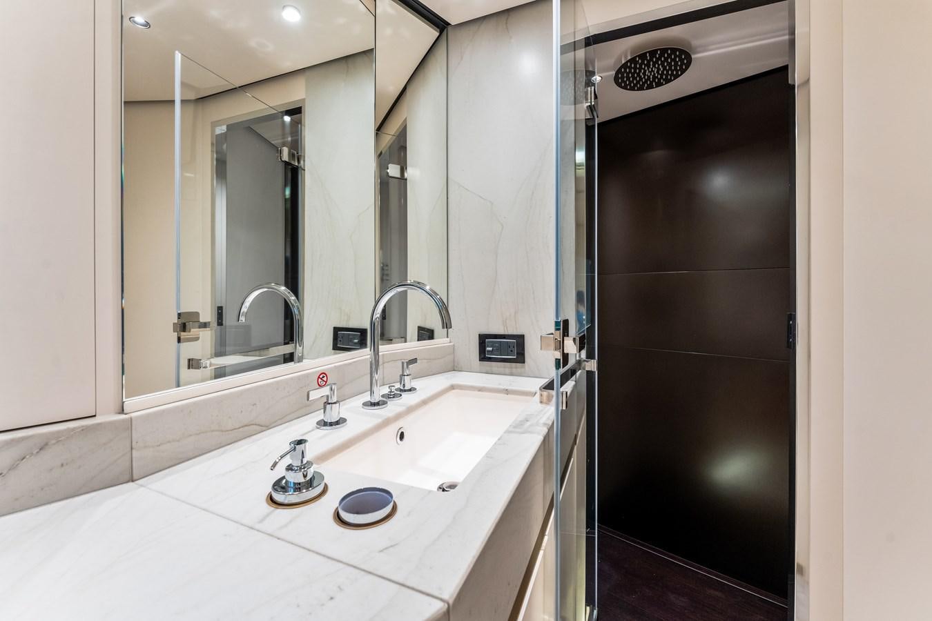a bathroom with a large mirror aboard EQUITES Yacht for Sale