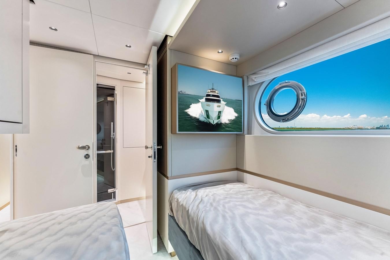 a room with a bed and a television aboard EQUITES Yacht for Sale