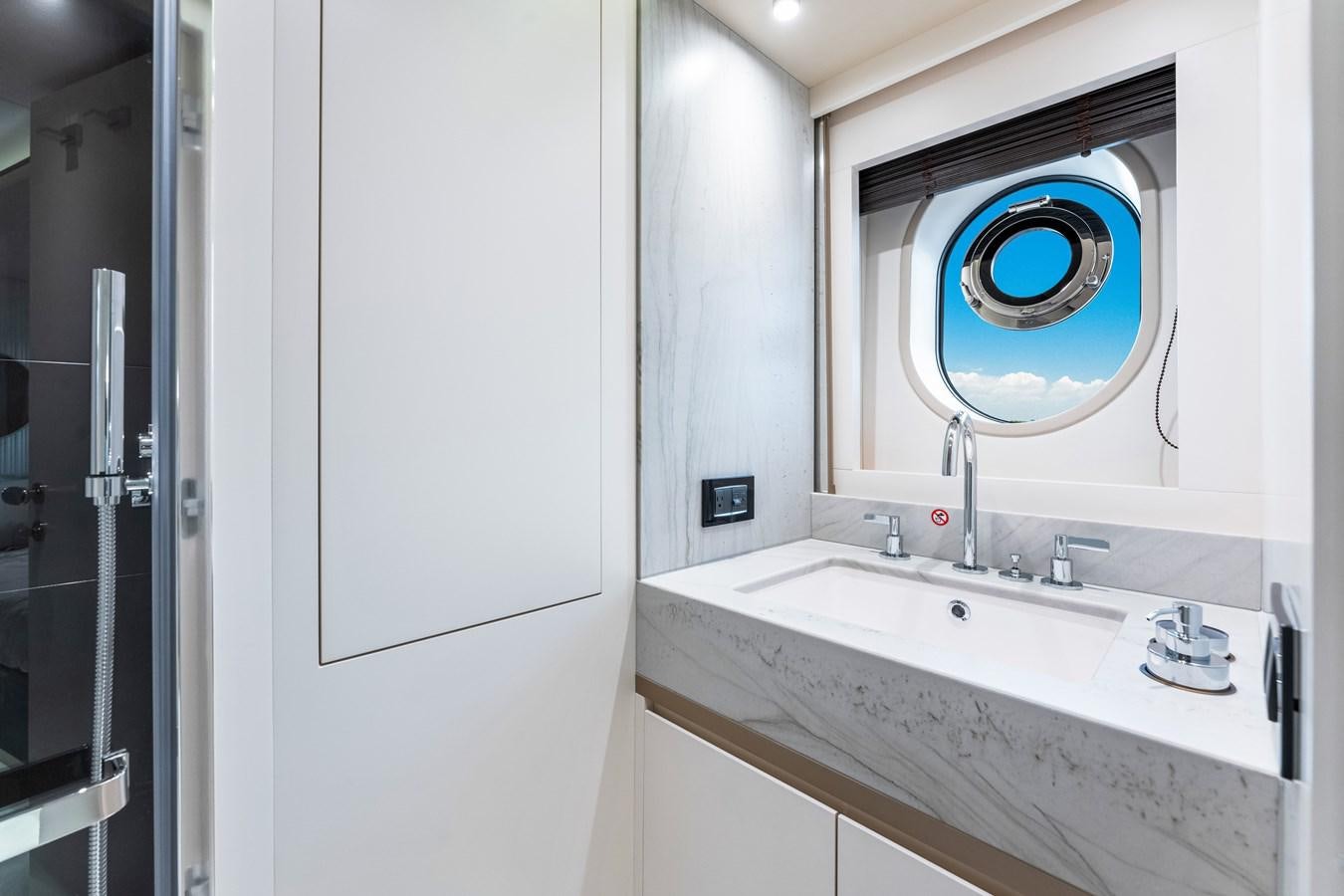 a bathroom with a sink and a mirror aboard EQUITES Yacht for Sale