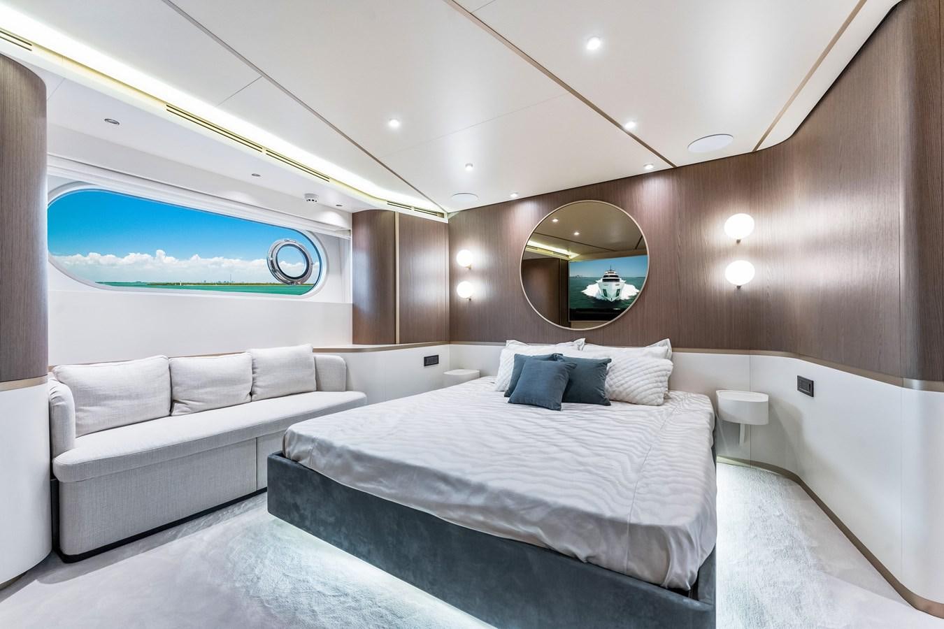 a room with a bed and a large mirror aboard EQUITES Yacht for Sale