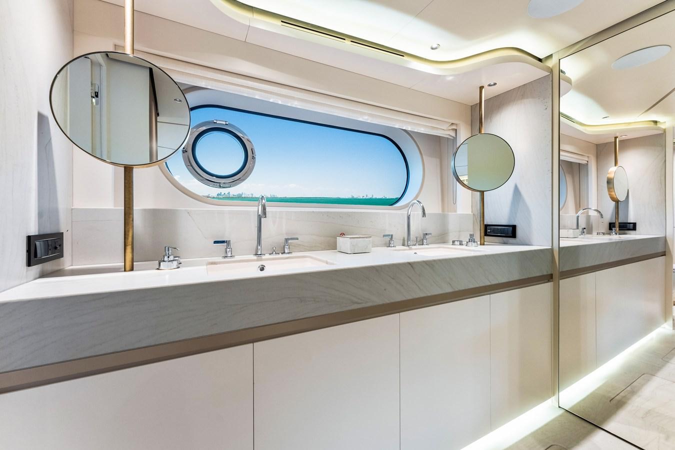 a bathroom with a large mirror aboard EQUITES Yacht for Sale