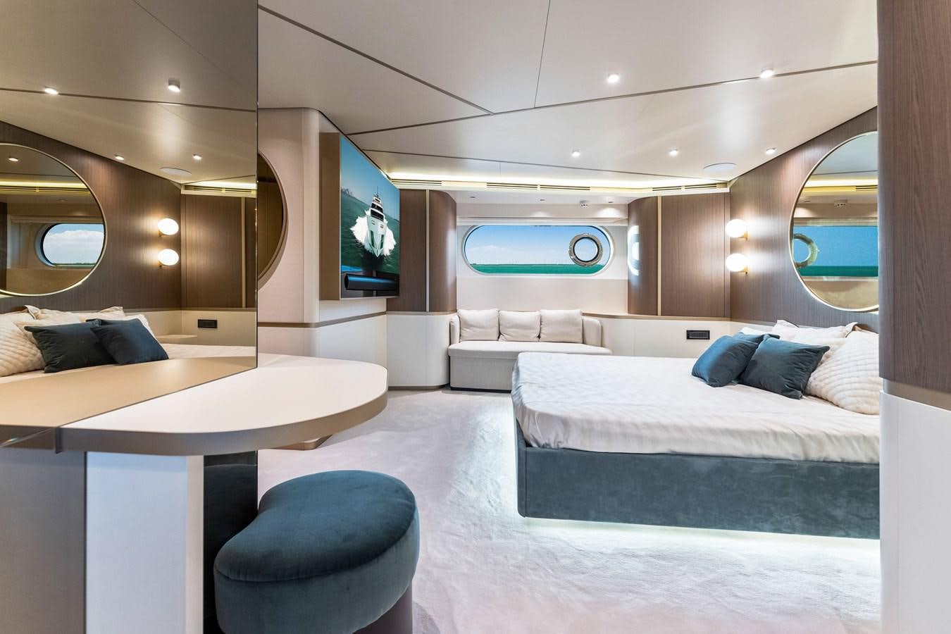 a room with a bed and a tv on the wall aboard EQUITES Yacht for Sale