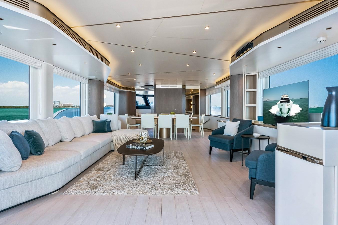 a living room with a large screen aboard EQUITES Yacht for Sale
