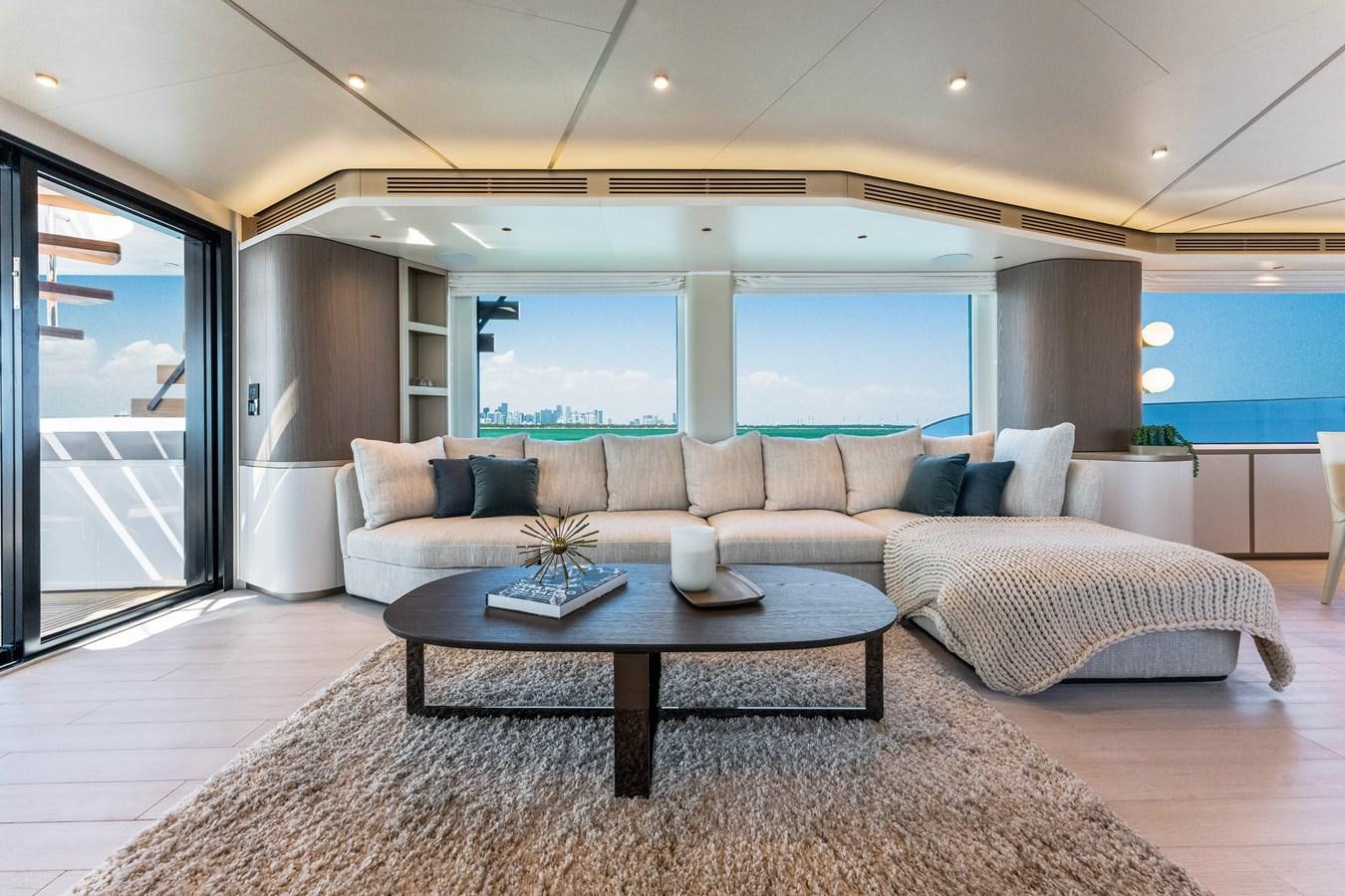 a living room with a couch and a table aboard EQUITES Yacht for Sale