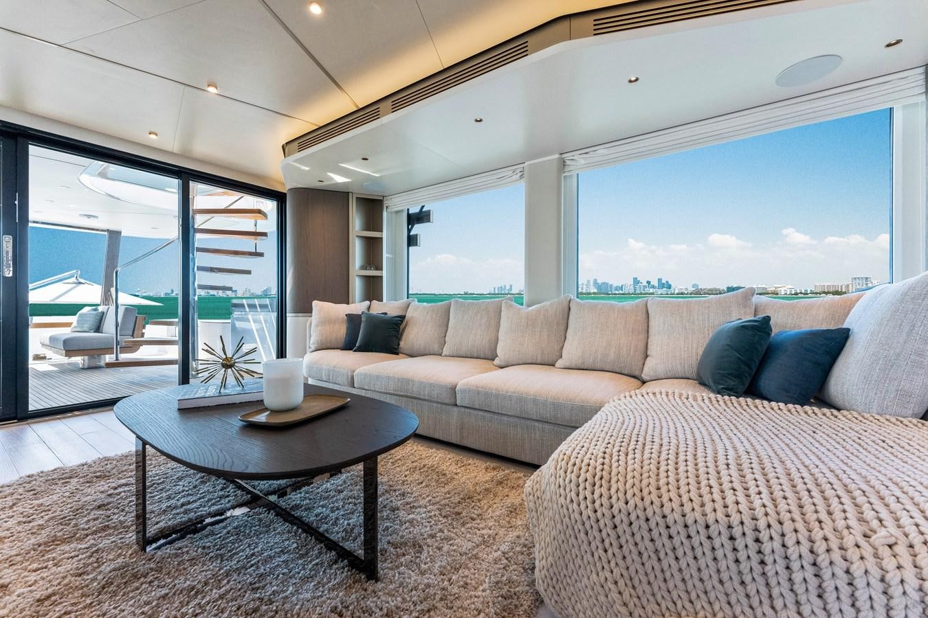 a living room with a couch and a table aboard EQUITES Yacht for Sale