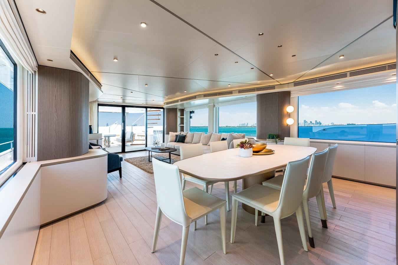 a large room with a table and chairs and a large window aboard EQUITES Yacht for Sale