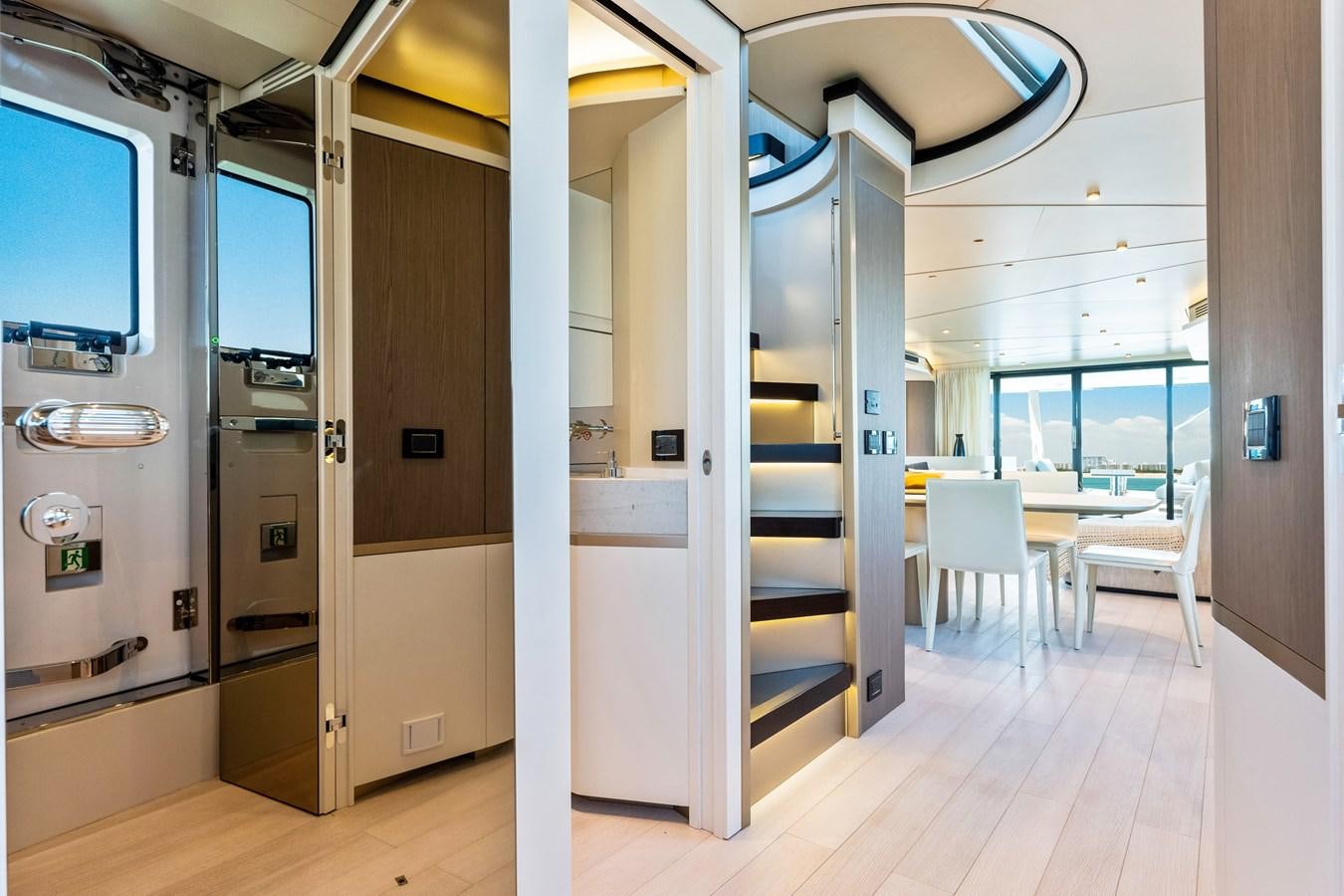 a room with a glass door and a table and chairs aboard EQUITES Yacht for Sale