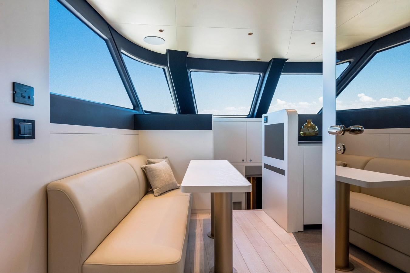 a room with a couch and a table and a window aboard EQUITES Yacht for Sale
