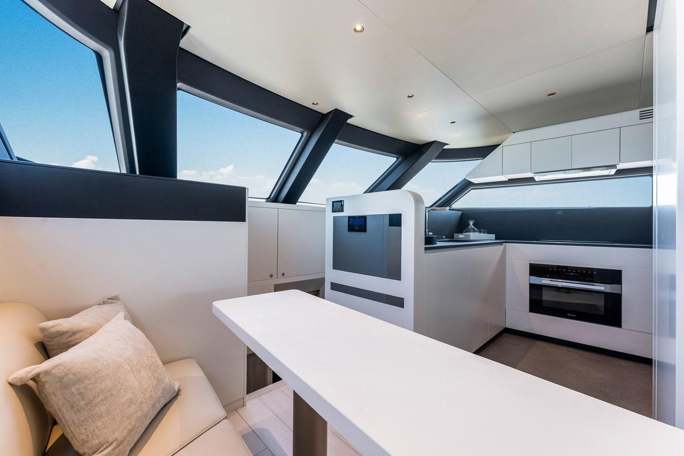 a modern kitchen with white cabinets aboard EQUITES Yacht for Sale