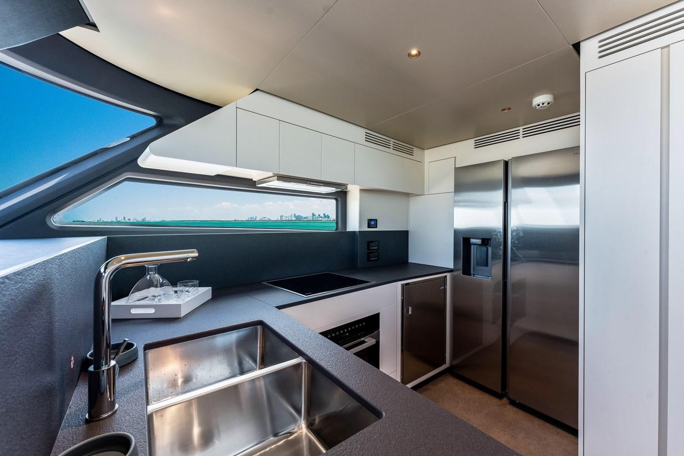 a kitchen with a stainless steel sink aboard EQUITES Yacht for Sale