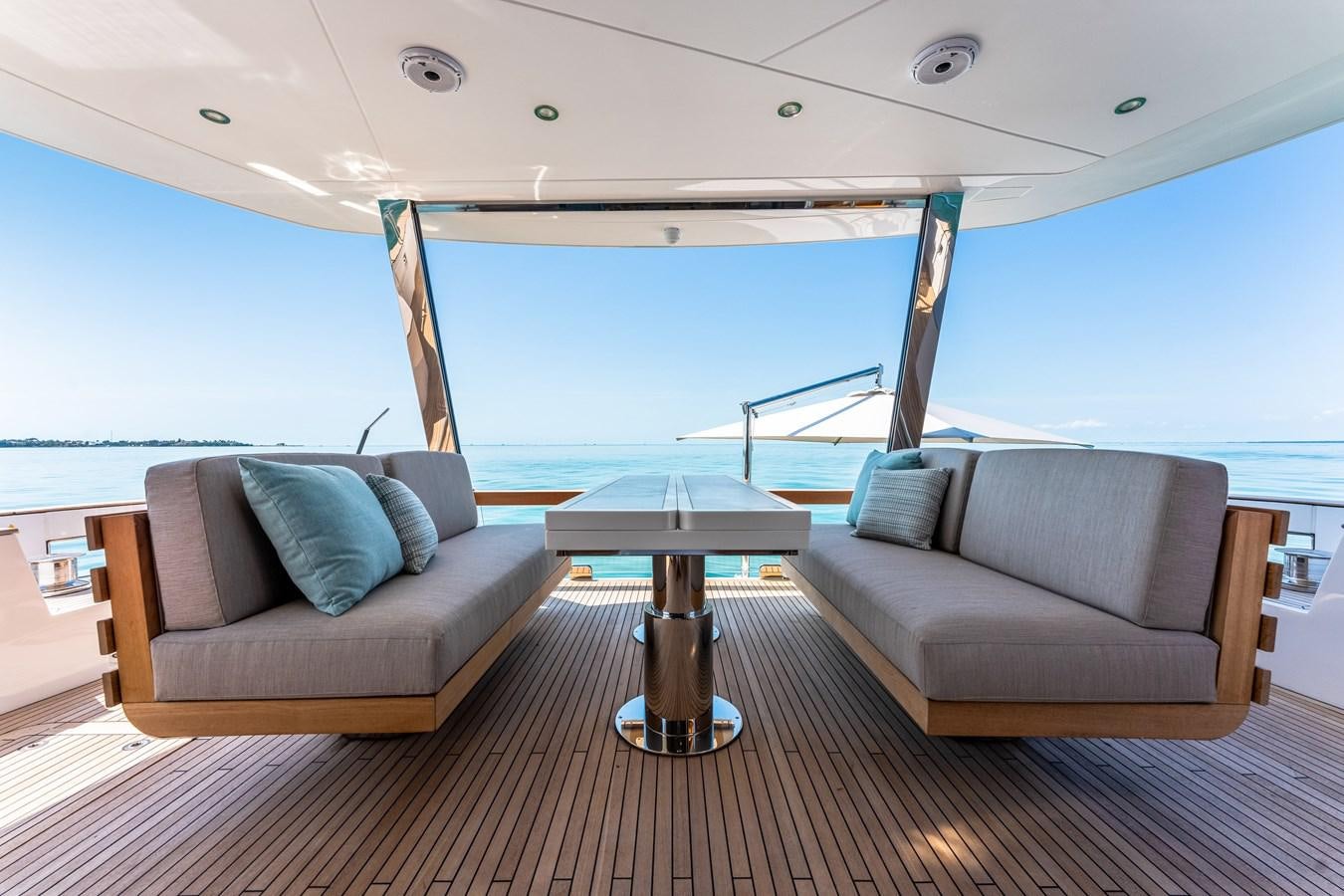 a living room with a large blue ocean aboard EQUITES Yacht for Sale