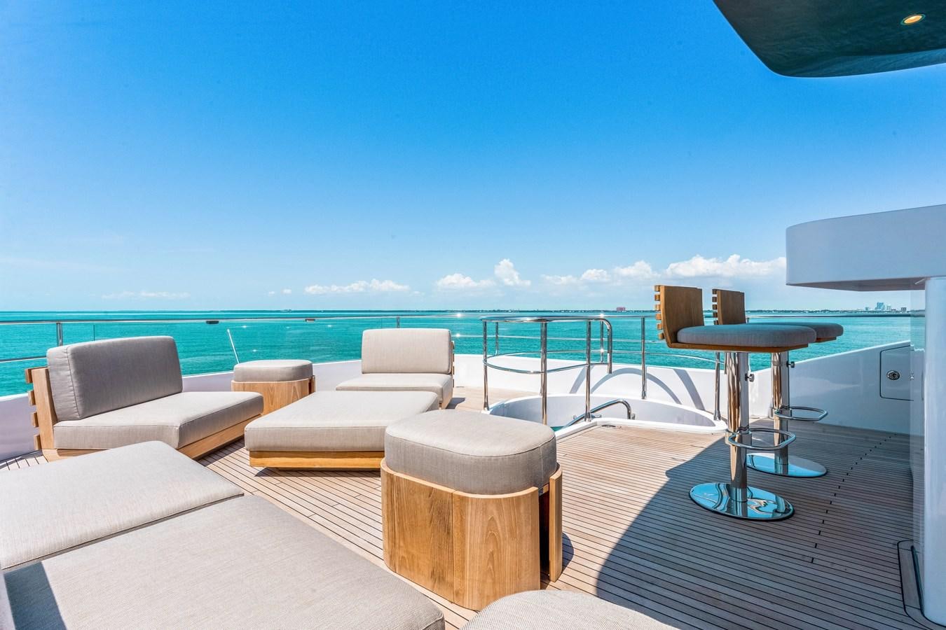 a room with a table chairs and a large body of water aboard EQUITES Yacht for Sale