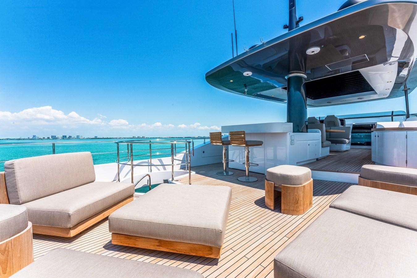 a room with a view of the ocean and a large cruise ship aboard EQUITES Yacht for Sale