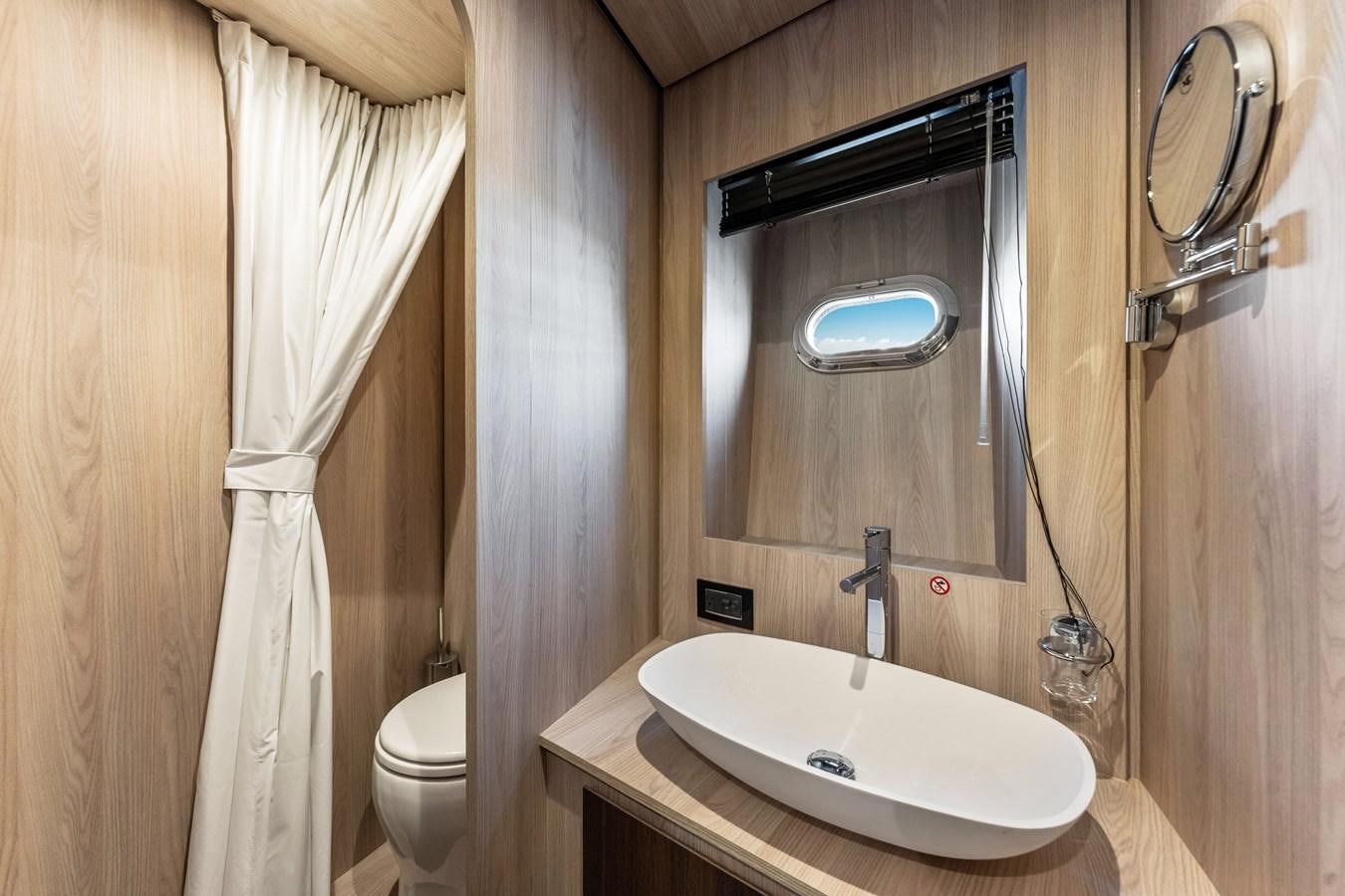 a bathroom with a sink and a mirror aboard EQUITES Yacht for Sale