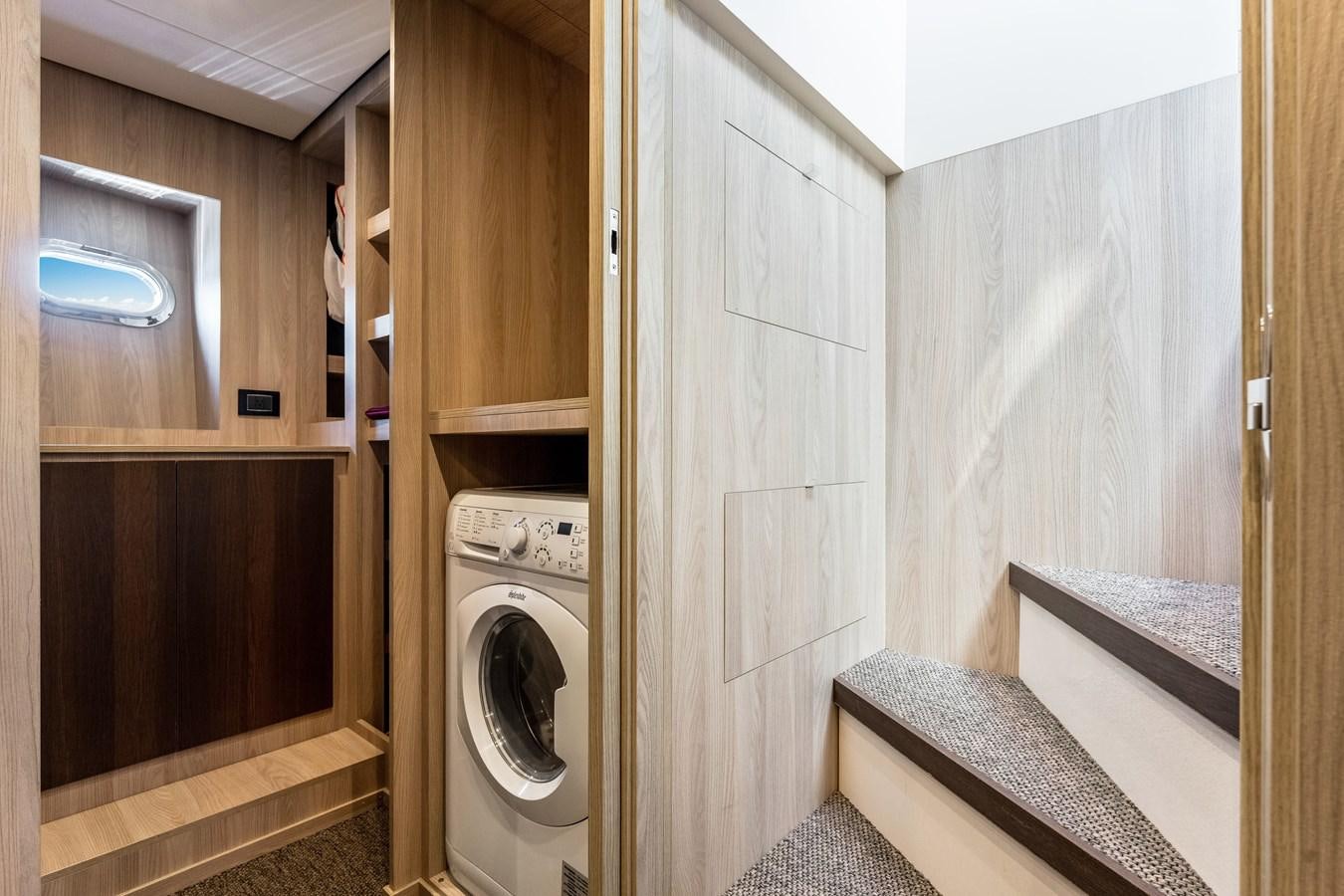 a washer and dryer in a room aboard EQUITES Yacht for Sale