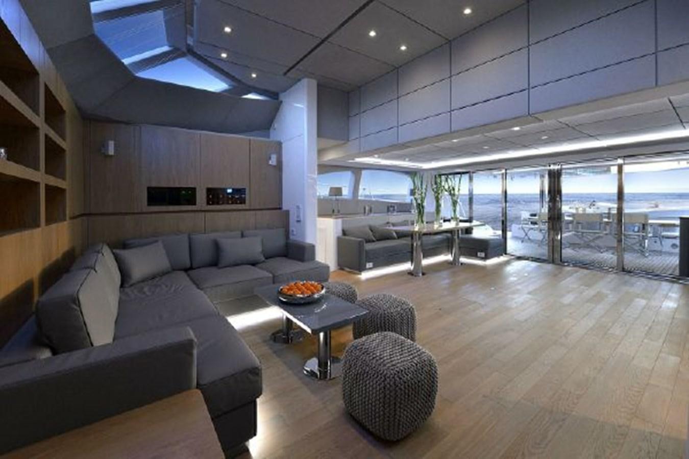 a room with a couch and a table aboard 2015 SUNREEF 70 Yacht for Sale