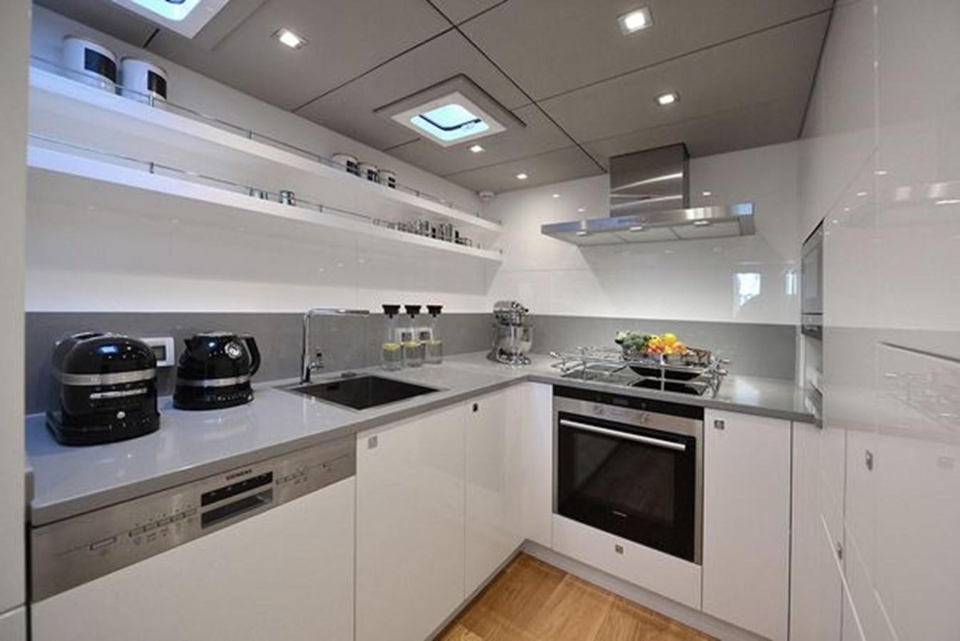a kitchen with white cabinets aboard 2015 SUNREEF 70 Yacht for Sale