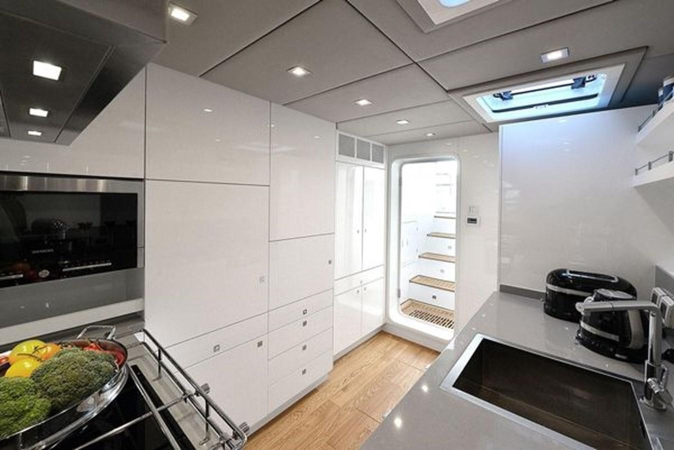a kitchen with white cabinets aboard 2015 SUNREEF 70 Yacht for Sale